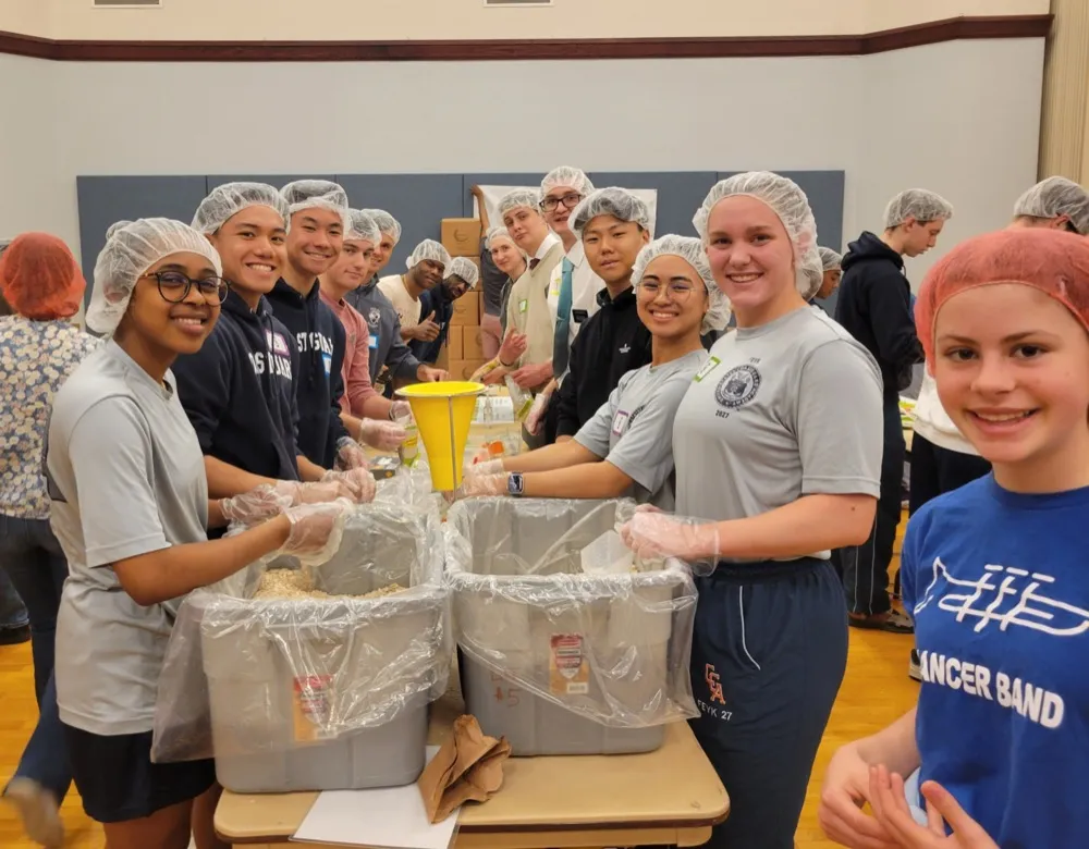 A faith community of all ages packing meals together