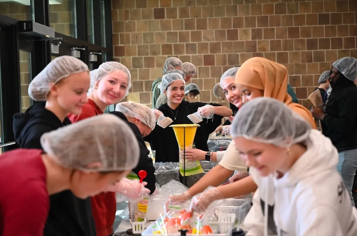 Volunteers working together at a Harvest Pack packing event